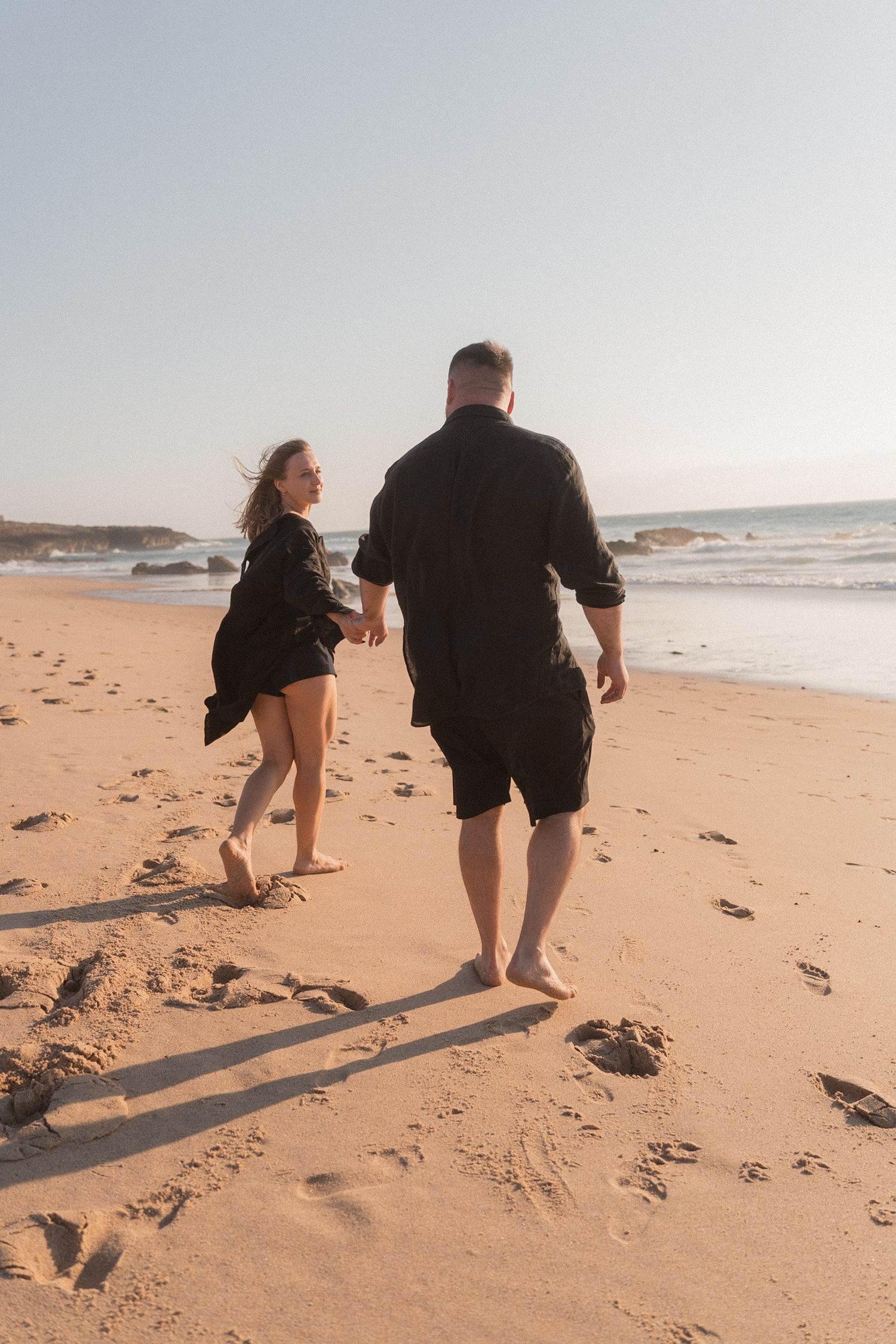 Couple photographed by the coast